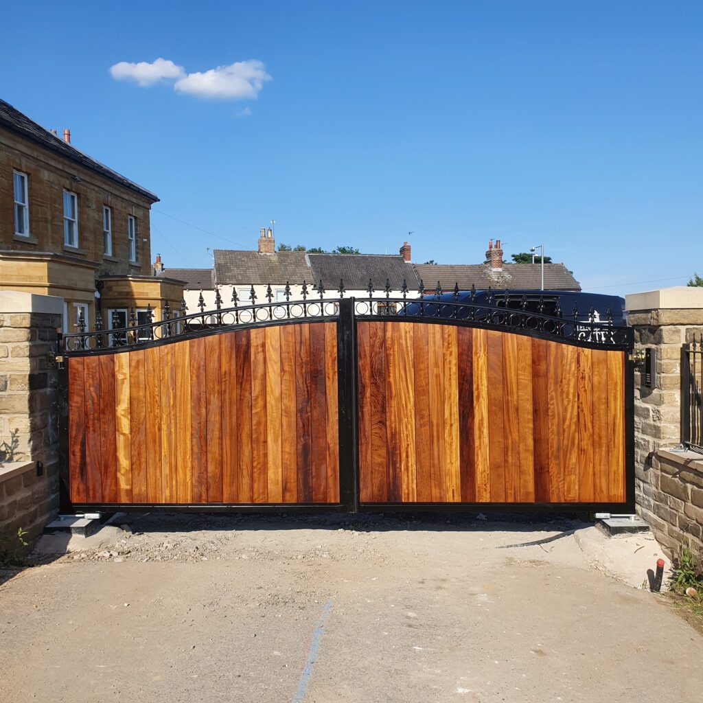 20210622_180122 Wooden driveway gates with steel frame and decorative finials