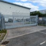 Metal vertical-bar sliding gate installed at the entrance of a commercial site