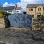 Durable dark grey arch top composite driveway gate with integrated letterbox for modern homes