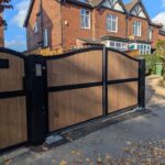 A pair of electric composite drivway gates fitted to a house