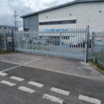 Metal vertical-bar sliding gate installed at the entrance of a commercial site