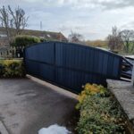 Stylish dark grey arch top composite driveway gate with secure automated sliding system