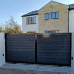 Flat top composite sliding gate installed at a modern residential property