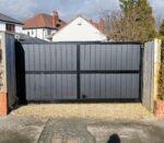 Flat top composite driveway gate with vertical composite boards and metal frame