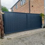Flat top composite sliding gate installed at a residential property entrance