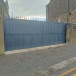Flat top composite driveway gate with composite boards and a metal frame
