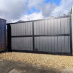 Flat top composite driveway gate with vertical composite boards and metal frame