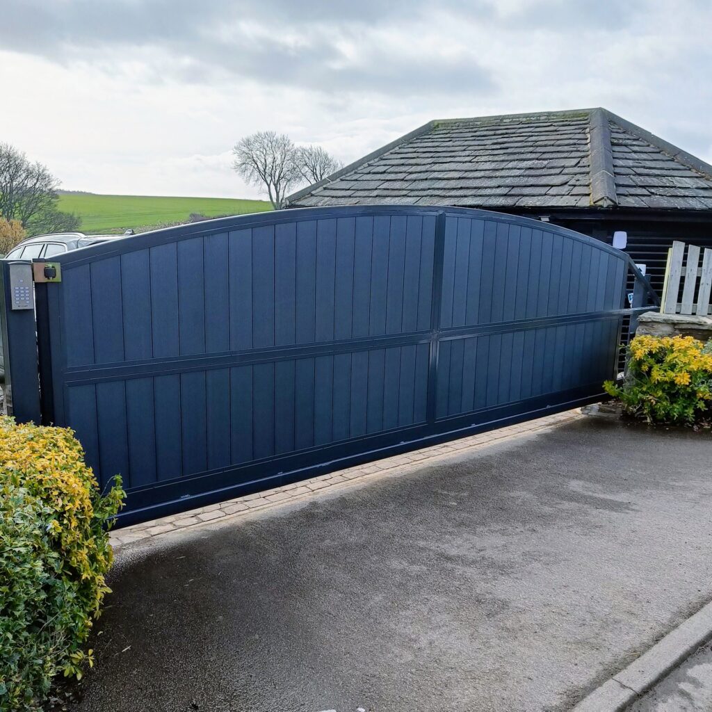 Curved dark blue composite gate with stone pillars