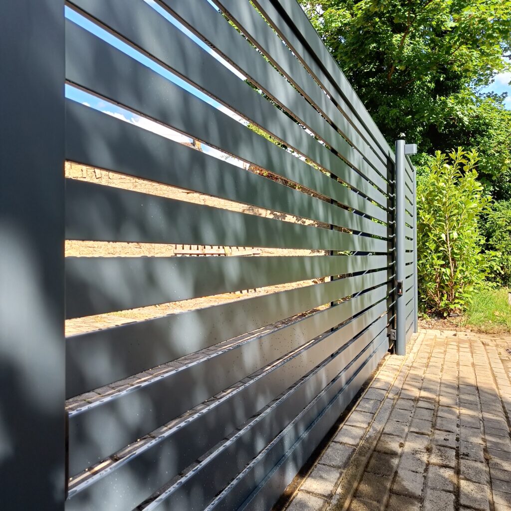 Modern grey aluminium sliding driveway gate with horizontal slats