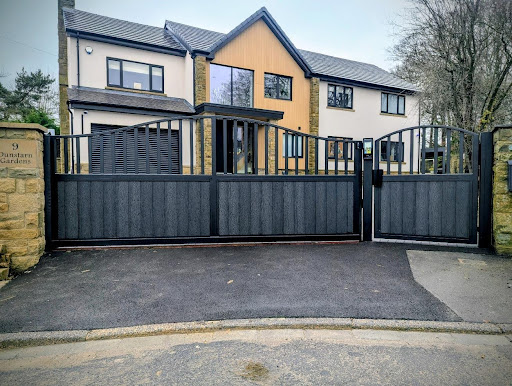 Modern detached house with black metal driveway gates and contemporary exterior design